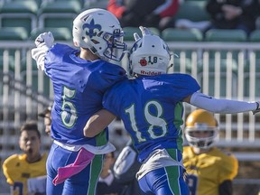 Bishop James Mahoney Saints Tanner Reiber (18) and Jared Ens (5) celebrate following a touchdown during the Saskatoon city high-school 3A football final at SMF Field in Saskatoon on Saturday, October 27, 2018.