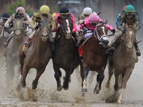 LOUISVILLE, KENTUCKY - MAY 04: Country House #20, ridden by jockey Flavien Prat, War of Will #1, ridden by jockey Tyler Gaffalione , Maximum Security #7, ridden by jockey Luis Saez and Code of Honor #13, ridden by jockey John Velazquez fight for position in the final turn during the 145th running of the Kentucky Derby at Churchill Downs on May 04, 2019 in Louisville, Kentucky.