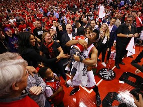 TORONTO, ONTARIO - MAY 25: Kyle Lowry #7 of the Toronto Raptors celebrates with his sons Kameron and Karter after defeating the Milwaukee Bucks 100-94 in game six of the NBA Eastern Conference Finals to advance to the 2019 NBA Finals at Scotiabank Arena on May 25, 2019 in Toronto, Canada. NOTE TO USER: User expressly acknowledges and agrees that, by downloading and or using this photograph, User is consenting to the terms and conditions of the Getty Images License Agreement.