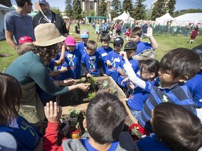 Kjelti Anderson leads a group of students at the Container Garden Art Project area during the Children's Festival at Kiwanis Park in Saskatoon, SK on Tuesday, June 5, 2018.