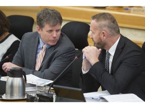 Saskatoon chief financial officer Kerry Tarasoff, right, speaks to city manager Jeff Jorgenson at city hall in late 2018.