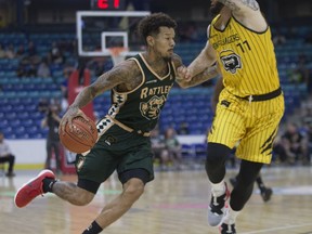 askatchewan Rattlers guard Negus Webster Chan moves the ball past Hamilton Honey Badgers forward Connor Gilmore during the game at SaskTel Centre in Saskatoon on Thursday, May 16, 2019.