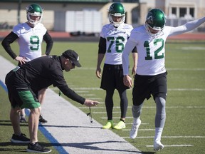 Craig Dickenson, left, continues to work with the special teams in his first season as the Riders' head coach.