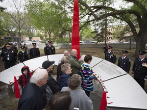 A crown of people look at the new monument during a Madd Canada unveiling of a monument for Sask. Victims of impaired driving outside city hall in Saskatoon, Sk on Saturday, May 25, 2019.