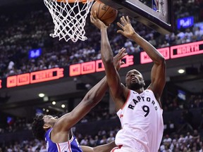 Toronto Raptors centre Serge Ibaka scores over Philadelphia 76ers guard Jimmy Butler during second half NBA playoff basketball action in Toronto on Tuesday, May 7, 2019.