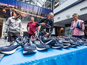 Brian Michasiw, second from right, from Brainsport demos shoes for Cameco employees before a lunchtime run as part of their Step Up for Mental Health initiative on April 30.