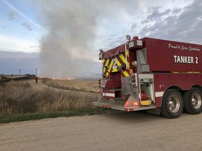 Members of Saskatoon's fire department worked to extinguish a grass fire near train tracks on May 14, 2019. Photo supplied by Saskatoon Fire Department.