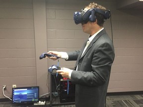 Sean Maw, a professor at the University of Saskatchewan's College of Engineering, demonstrates VR technology developed by a local technology company and intended to give engineering students a chance to learn about trusses used in bridges and other construction projects. Saskatoon StarPhoenix photo by Alex MacPherson.