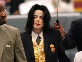 In this May 25, 2005 file photo, Michael Jackson arrives at the Santa Barbara County Courthouse for his trial in Santa Maria, Calif. A settlement has been reached in a lawsuit between Tohme Tohme, a former manager of Michael Jackson, and his estate. The settlement announced Thursday, May 23, 2019, ends one of the last remaining legal fights involving Jackson's estate and comes just short of the 10th anniversary of the pop superstar's death.