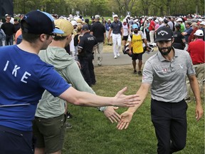 Adam Hadwin of Canada greets spectators as he walks to the 10th tee during the final round of the PGA Championship golf tournament, Sunday, May 19, 2019, at Bethpage Black in Farmingdale, N.Y.