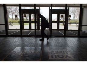 A student walks through the University of Regina near the Archer Library. Tuition rates are increasing for students of the school.