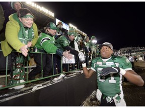 Geroy Simon celebrates with Saskatchewan Roughriders fans on Nov. 24, 2013 after scoring two touchdowns for the home side in a 45-23 Grey Cup victory over the Hamilton Tiger-Cats. Simon, 38, was a member of a veteran-laden championship team that year.