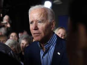 In this May 1, 2019, photo, former Vice President and Democratic presidential candidate Joe Biden greets audience members during a rally in Iowa City, Iowa. Biden's candidacy didn't scare off any of his rivals, who lined up one after another in a race they believed was truly up for grabs. Did they underestimate him? Biden's political liabilities are many, but he's quickly emerged as an overwhelming front-runner who's dominating the race for money and political oxygen in the crowded 2020 Democratic contest.