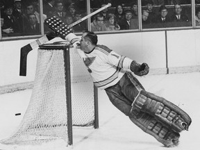 St. Louis Blues goaltender Glenn Hall stretches to knock the puck over his net at the Montreal Forum during a February 1968 game. CREDIT: Mac Juster/Montreal Star