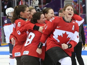 SOCHI: FEBRUARY 20, 2014 -- Hayley Wickenheiser (R) and Team Canada celebrate their overtime hockey gold medal win against the USA  at the Sochi 2014 Olympic Games, February 20, 2014. Photo by Jean Levac/Postmedia News