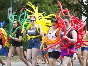 Attendants march down the street during the Saskatoon Pride Parade June 23, 2018.