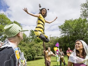 Micheal Martin, left, and Mara Teare, right, listen to a bee played by Megan Zong in Theatre In The Park's production of the Young Ones in Saskatoon, June 24, 2019.