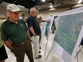 People examine maps of proposals for a south Saskatoon perimeter freeway during an information session at the German Concordia Club, Thursday, June 25, 2015.