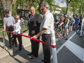 A crowd of cyclists attended the grand opening of the new Fourth Avenue protected bike lanes on May 19, 2016. Mayor Don Atchison; Alan Wallace, director of planning and development; Don Cook, manager of long range planning; and Cathy Watts on behalf of Saskatoon Cycles cut the ribbon as they officially declared the lanes open.