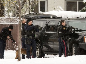 Saskatoon police officers, including members of the tactical support unit, outside the home where Joshua Megeney died on Oct. 6, 2016. Const. Jesse Jackson, who fired the shot that killed Megeney inside the home, is on the right.