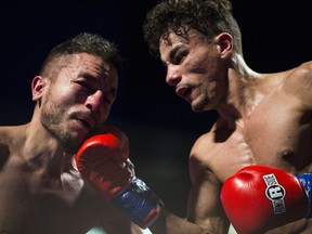 George Castro (left) receives a punch from Wayne Smith during a pro boxing card at SaskTel Centre in Saskatoon on Nov. 25, 2017.