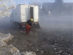 City of Saskatoon workers attend to a water main break that flooded Mckercher Drive near the intersection with Eighth Street East in Saskatoon, SK on Friday, February 8, 2019.
