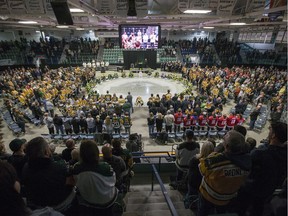 Family members and friends light candles during the Humboldt Broncos First Year Memorial service at Elgar Petersen Arena in Humboldt, SK on Saturday, April 6, 2019.