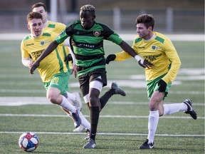 Calgary Foothills forward Moses Danto runs the ball under pressure from the Saskatchewan Selects defence in the Saskatchewan Summer Soccer Series in Saskatoon on Friday, May 4 2019.