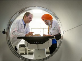 Professors Ali Honaramooz, left, and Jaswant Singh prepare a fossil to be imaged at the Western College of Veterinary Medicine's new PET-CT scan.