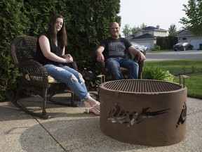 Kristi Gibson and Eric Gibson from the Saskatchewan arm of Alberta based Pitboss Customs sit beside a custom fireplace in Saskatoon, Sk on Saturday, June 1, 2019.