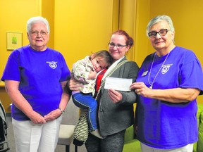 Peggy Ganton (left) and Denis Taylor (right) of the Royal Purple Elks #50 present a cheque in Prince Albert on May 28, 2019 to Ember Spitzack and two-year-old Aria Gagne. The contribution was made to help Spitzack offset travel, food and lodging expenses while Aria recovered from cochlear implant surgery on May 31. Aria lost her hearing after contracting meningitis. The Royal Purple Elks have partnered for years with the Saskatchewan Pediatric Auditory Rehabilitation Centre (SPARC) at Royal University Hospital in Saskatoon. (Peter Lozinski / Prince Albert Daily Herald)