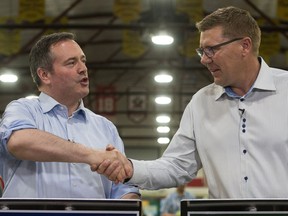 Saskatchewan Premier Scott Moe, right, shakes hands with Alberta Premier Jason Kenney during the Saskatchewan Oil & Gas Show held at the Crescent Pointe Centre in Weyburn. BRANDON HARDER/ Regina Leader-Post