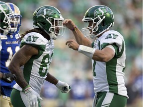 Riders quarterback Zach Collaros (right) and receiver Naaman Roosevelt celebrate a touchdown during Thursday's pre-season action.