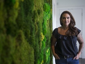 Shondra Boier owner of PLANT.yxe who creates art using preserved moss stands by one of her creations at a clients home in Saskatoon, Sk on Saturday, June 8, 2019.