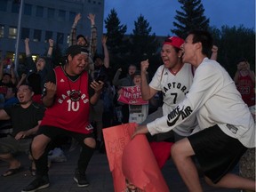 Darren Severight (L) celebrates after the Toronto Raptors win game 6 of the NBA championships during a watch party at City Hall in Saskatoon, June 13, 2019.