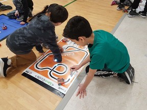 The RoboX program was designed to teach students digital literacy through coding, and building robots. Pictured above, students are coding their robots to follow lines or to follow a bright light.