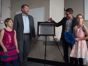 From left, The Crescents School Grade 4 student Violet Armistead, Doug Opseth, chair of the The Crescents School community council, Adam Hicks, vice-chair of Regina Public Schools and Grade 6 student Lily Armistead stand next to a recently unveiled plaque which honours the school's name change from Davin School to The Crescents School.