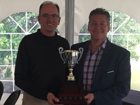 Brian Humble (left) is the 2019 Saskatoon Auto Clearing city senior men's golf champion. On hand for the trophy presentation is Auto Clearing TJ Smith.