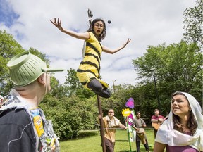 Micheal Martin, left, and Mara Teare, right, listen to a bee played by Megan Zong in Theatre In The Park's production of the Young Ones in Saskatoon, June 24, 2019.