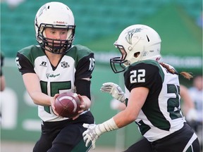 REGINA, SASK : June 29, 2019  -- Saskatoon Valkyries quarteback Alex Eyolfson (15) hands the ball off to running back Sam Matheson (22) during the Women's Western Canadian Football League (WWCFL) final against the Regina Riot at Mosaic Stadium. BRANDON HARDER/ Regina Leader-Post