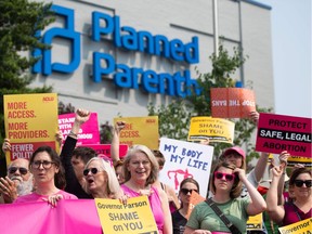 (FILES) In this file photo taken on May 31, 2019, Pro-choice supporters and staff of Planned Parenthood hold a rally outside the Planned Parenthood Reproductive Health Services Center in St. Louis, Missouri. - The Missouri state health department on June 21, 2019, denied a license to the only abortion clinic in the midwestern US state, but it will remain open pending a court ruling. The denial of the license was announced by Planned Parenthood, which operates the abortion clinic in the city of St. Louis. "Missouri's health department weaponized a regulatory process to deny an abortion license to the last remaining health center in Missouri that provides abortion," Planned Parenthood said in a tweet.