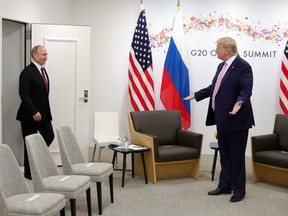 U.S. President Donald Trump, right, attends a meeting with Russia's President Vladimir Putin during the G20 summit in Osaka on June 28, 2019. (MIKHAIL KLIMENTYEV/AFP/Getty Images)