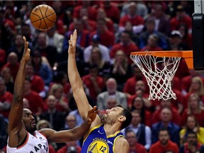 Toronto Raptors center Serge Ibaka (9) shoots the ball against Golden State Warriors center Andrew Bogut (12) in game two of the 2019 NBA Finals at Scotiabank Arena.