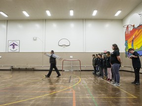The Peacekeeper cadets take part in drill lead by Saskatoon Police Constable Marc Belanger, left, at Princess Alexandra Community School in Saskatoon
