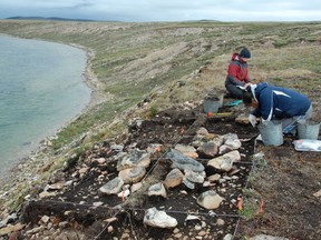 Researchers excavate a site on Victoria Island, Nunavut in this undated handout photo. Genetic research is showing the Indigenous people of Canada's western Arctic are descended from some of the first humans to live in North America. A newly published paper says the Dene who now live along the Mackenzie River have roots thousands of years older than previously thought.