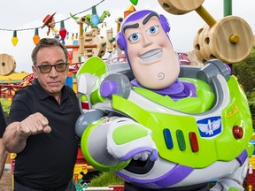LAKE BUENA VISTA, FLORIDA - JUNE 08: In this Handout provided by Disney Resorts, Stars from DisneyPixars Toy Story 4 Woody (in costume), Tom Hanks (2nd-L), Tim Allen (2nd-R) and Buzz Lightyear (in costume) appear with characters from the film inside Toy Story Land at Disney's Hollywood Studios at Walt Disney World Resort on June 8, 2019 in Lake Buena Vista, Florida.