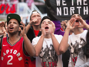 Toronto Raptors fans cheer in 'Jurassic Park,' outside the Scotiabank Arena in Toronto.
