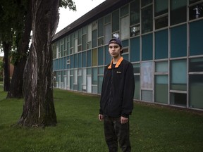 Teddy Shingoose is one of hundreds of Indigenous students set to graduate from high school. Shingoose stands outside Aden Bowman Collegiate in Saskatoon this year in Saskatoon, Sask. on June 20, 2019.