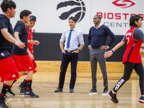 Canadian Prime Minister Justin Trudeau (left) and Toronto  Raptors president and general manager Masai Ujiri watch visiting students of La Loche Community School in Saskatchewan on the basketball court at the BioSteel Centre, where the Toronto Raptors practice, in Toronto, Ont. on Friday January 13, 2017.  Masai Ujiri, Toronto Raptors president and general manager, hosted a group of 10 kids, plus two teachers, from La Loche, Saskatchewan. Ernest Doroszuk/Toronto Sun/Postmedia Network