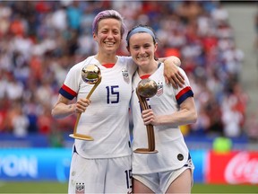 Megan Rapinoe of the USA celebrates with the Golden Ball award and teammate Rose Lavelle celebrates with the Bronze Ball award following the 2019 FIFA Women's World Cup France Final match between The United States of America and The Netherlands at Stade de Lyon on July 07, 2019 in Lyon, France.